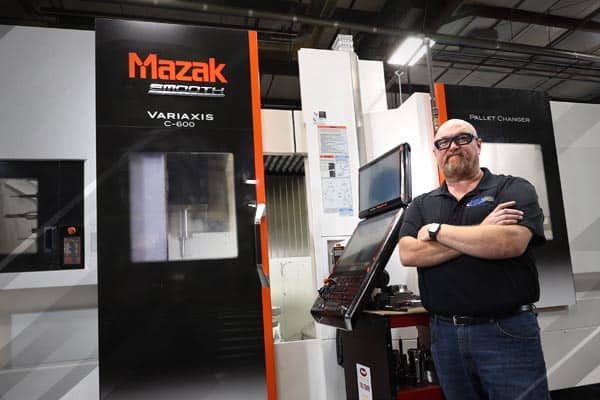 Mazak 5-axis machine operator with his arms folded